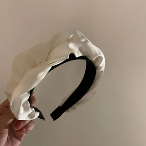 Elegant French pleated satin headband in creamy white with contrasting black base