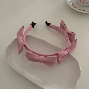 Pink satin bow headband for women featuring four elegant ribbon bows on a French style hairband