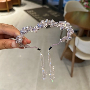 Detail of handcrafted crystal headband featuring purple aurora beads and detachable tassels