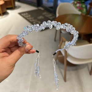 Detail of handcrafted crystal bead headband with detachable fringe tassels in light blue