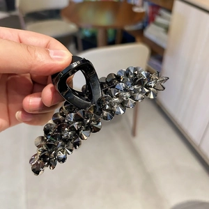 Elegant large shark clip with dark gray crystals on a black base for thick hair