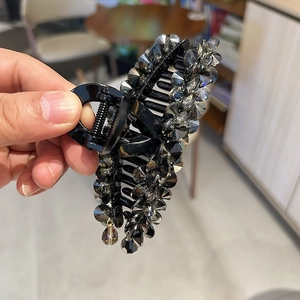 Elegant large black hair claw clip with grey crystals and water-drop pendant