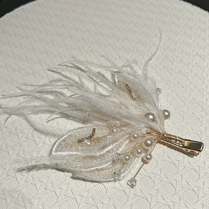 Elegant white butterfly hair clip with feathers, pearls, and crystals for princess hairstyles