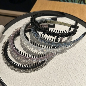 Detail showing five rhinestone non-slip headbands with teeth in various colors