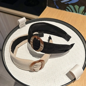 Close-up of velvet wide headbands with tortoiseshell ring detail in black and beige