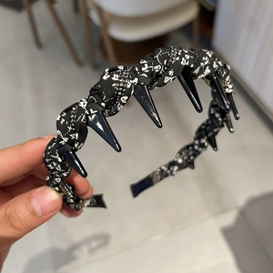 Detailed view of floral headband with teeth and sparkling small black rhinestones