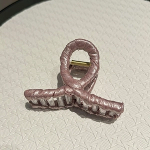 Elegant dusty pink fabric hair claw clip with satin finish and golden spring detail