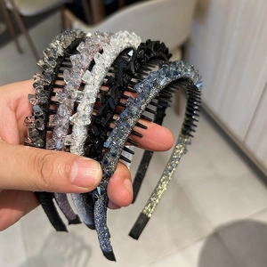 Close-up of anti-slip toothed headband featuring sparkling crystal geometric decorations