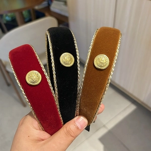 Detail of velvet headbands in wine red, black and caramel with gold metal accent