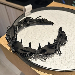 Elegant black satin bow headband with beaded trim and non-slip inner teeth for women