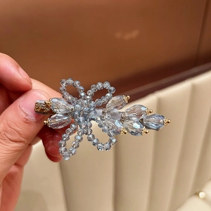 Handcrafted light blue crystal flower hair clip with golden accents for women