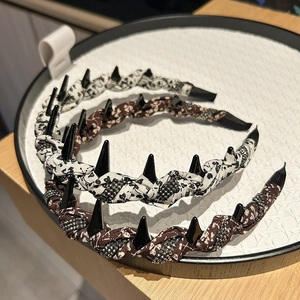 Detail of floral and leopard knotted headbands with unique black decorative spikes