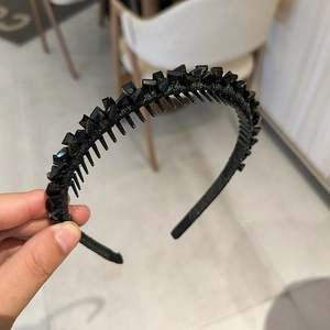 Detail shot of black rhinestone headband with non-slip inner teeth for secure grip