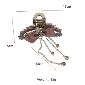 Detail showing pink mesh bow hair claw dimensions and crystal tassel pendant length