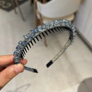 Close-up of light blue crystal headband showing non-slip teeth and sparkling rhinestones