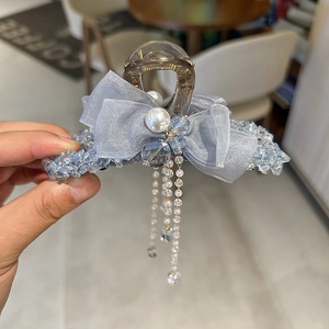 Elegant tea-colored hair claw with light blue mesh bow, pearls and long tassels