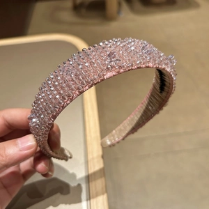 Detail of pink padded headband with hand-sewn crystal beads and luxury satin texture