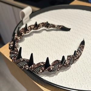 Close-up of floral fabric headband with sparkling silver crystals and anti-slip teeth