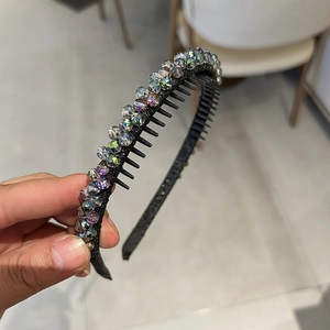 Close-up of black non-slip headband featuring sparkling crystal rhinestones and inner hair teeth