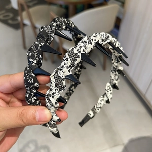 Close-up of floral leopard print headbands featuring punk style black decorative spikes