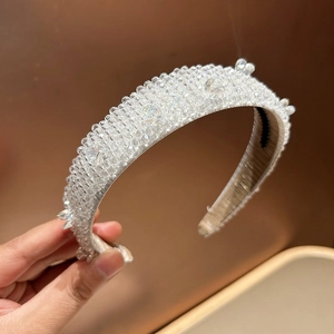 Close-up of handcrafted crystal beaded headband with clear glass rhinestones detail