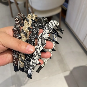 Detail showing various floral fabric headbands with small rhinestones and woven texture