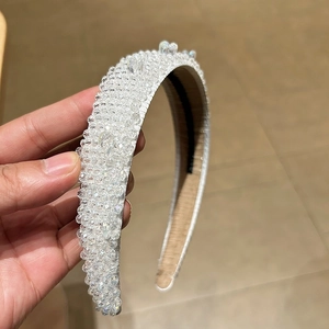 Close-up of white crystal beaded wide headband featuring intricate handmade pearl textures