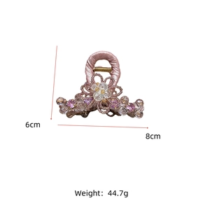 Detail view of pink crystal flower hair claw clip with dimensions 8cm by 6cm