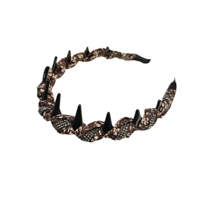 Floral print hairband with punk spikes and silver rhinestones on a white background