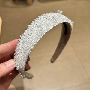 Detail of handmade baroque wide headband with clear crystal beads and luxury cluster