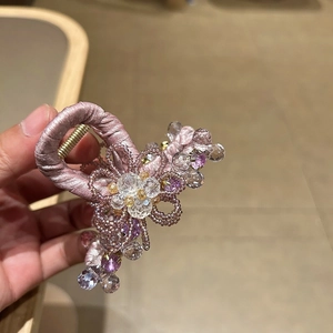 Elegant purple crystal flower hair claw clip with satin fabric and beaded floral design