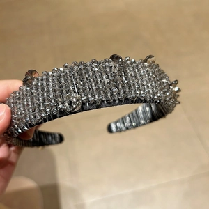Detail of grey handmade crystal beads and droplets on a wide Baroque style headband