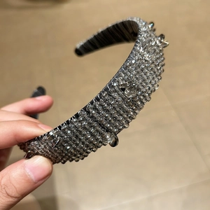 Detailed shot of handmade baroque headband with smokey crystals and silver spikes