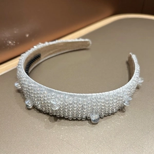Detailed macro view of crystal beaded headband with non-slip comb teeth and silver sequins