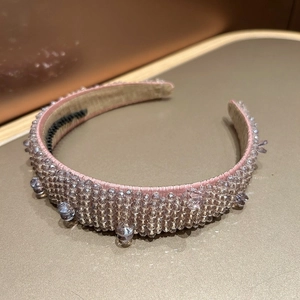 Close-up of handmade baroque headband with pink satin and purple crystal beads