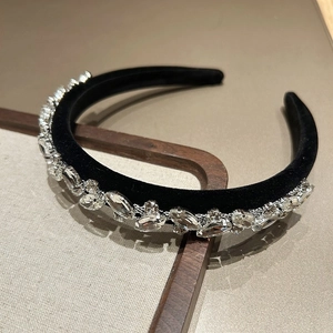 Detailed view of luxury black velvet headband with sparkling silver-clawed rhinestones