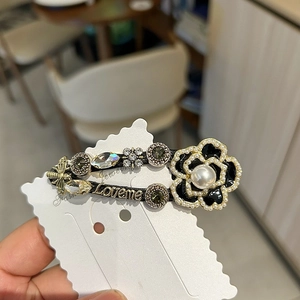 Vintage camellia hair clip with pearls and bee detailing in French luxury style