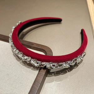 Close-up of sparkling crystals on luxury wine red velvet headband for elegant styling