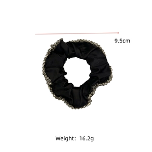 Detail view of 9.5cm black silk scrunchie with silver crystal beads and size data