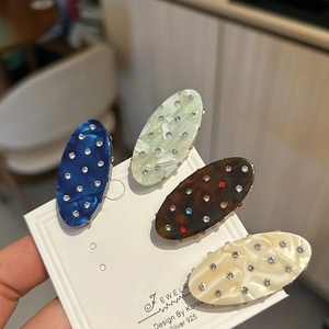 Glittering crystal oval duckbill hair clips in diverse acetate colors and textures