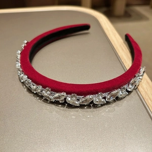 Close-up of luxury red velvet headband with sparkling crystal rhinestones detailing