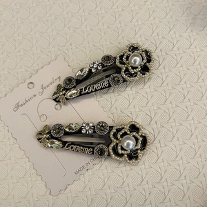 Vintage camellia hair clips with pearls, bees and crystal Loveme charms on white background