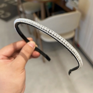 Détail d'un serre-tête avec perles, strass et picots antidérapants pour coiffure chic