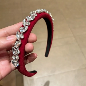 Sparkling rhinestones on a burgundy velvet headband with luxurious crystals and non-slip inner