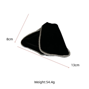 Detail view of a black velvet hair clip with rhinestone edges measuring 8cm by 13cm