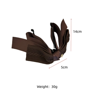 Detail view of 14cm brown knit bow banana hair clip with golden metal buckle and measurements