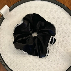 Elegant black velvet hair scrunchie featuring a sparkling silver rhinestone wavy edge