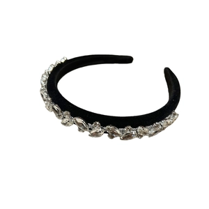 Elegant black velvet headband with shimmering rhinestones in a wavy luxury design