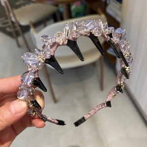 Detail of light purple crystal beads and pink satin headband with inner hair comb teeth