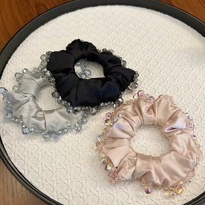 Three-piece set of satin crystal scrunchies in black, silver, and champagne colors